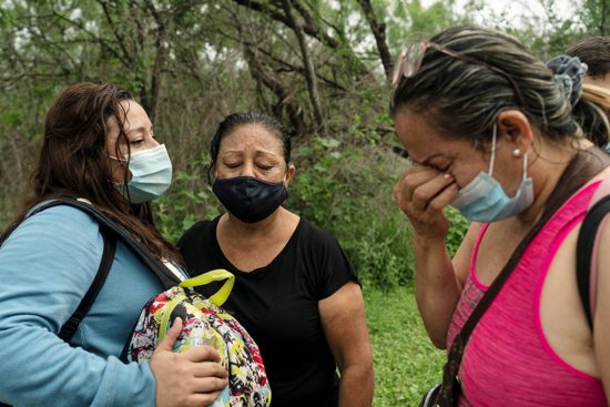 Migrants from Venezuela seeking asylum in the U.S. react as they wait to be transported by Border Patrol after crossing the Rio Grande into Del Rio, Texas, May 27, 2021.