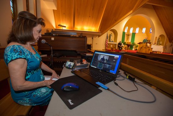 Mary Beth Hess works on livestreaming Mass at St. Jerome in Maplewood June 15.