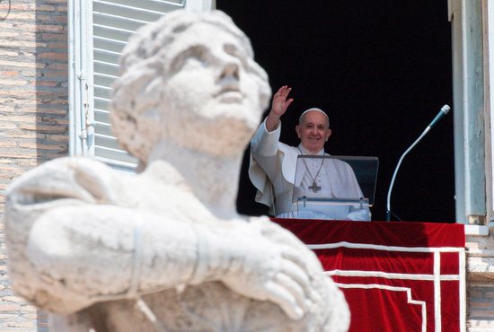 Pope Francis greets the crowd as he leads the Angelus from the window of his studio overlooking St. Peter's Square at the Vatican June 13, 2021.