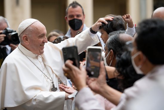 Pope Francis greets a child during his general audience in the San Damaso Courtyard of the Apostolic Palace at the Vatican June 2, 2021. 