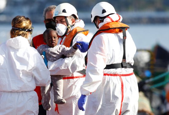 A child migrant is transferred to a Red Cross tent, in the port of Arguineguin, on the island of Gran Canaria, Spain June 4, 2021.