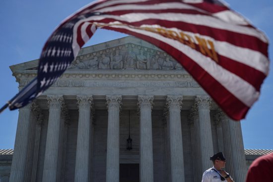 A U.S. flag flies in front of the Supreme Court in Washington June 25, 2018.