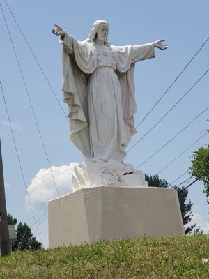 A statue of the Sacred Heart of Jesus outside St. Lawrence Basilica in Asheville, N.C., is seen cleaned and restored July 4, 2021, after vandals defaced it with gallons of oil-based red paint.