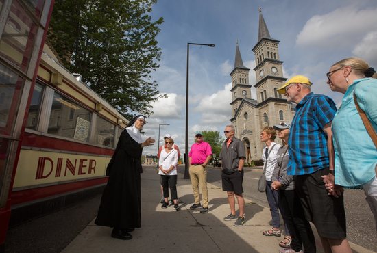 From left, actress Michelle Berg as Sister Celeste stands in front of the iconic Mickey’s Diner restaurant in downtown St. Paul July 8 as she talks about the history of the city to those taking one of her tours: Maribeth and Jim (behind) Bedtke, Randy Rheingans, Jack and Kris Harlan, Pam Rheingans, and Randy and B.J. Schwartzhoff.