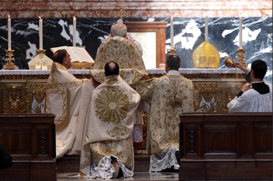 Cardinal Walter Brandmuller elevates the Eucharist during a Tridentine-rite Mass at the Altar of the Chair in St. Peter's Basilica at the Vatican May 15, 2011.