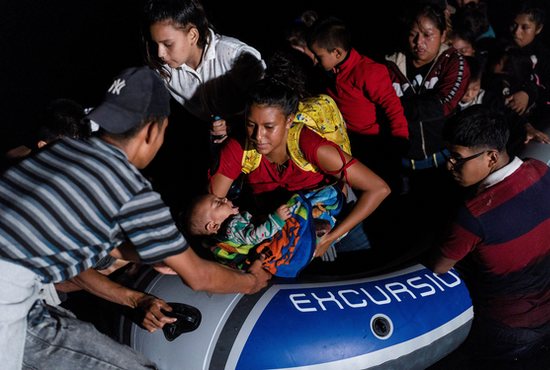 Asylum-seeking migrant families from Central America disembark from an inflatable raft after crossing the Rio Grande into the United States from Mexico in Roma, Texas, July 29, 2021. 