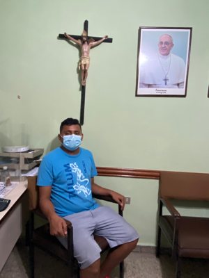 Jose Andres Martinez sits for an interview Aug. 17, 2021, at Our Lady of Mount Carmel Church in San Salvador, El Salvador. Martinez, a former sacristan, recently returned to his native El Salvador after six attempts to cross the U.S.-Mexico border.