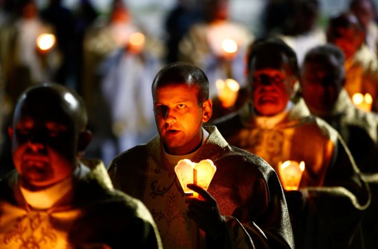 Catholic clergymen carry candles during the annual feast of the Icon of the Mother of God procession July 5, 2019, in Budslau, Belarus.