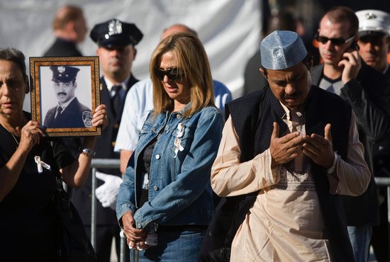 A Muslim man in New York City prays with others at the reflecting pool at Ground Zero Sept. 11, 2010.