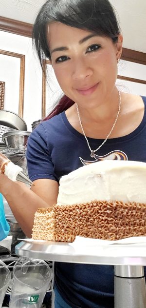 Lani Pascual, a member of Our Lady of the Greenwood Parish in Greenwood, Ind., is seen with one of her oven-baked creations in this undated photo.