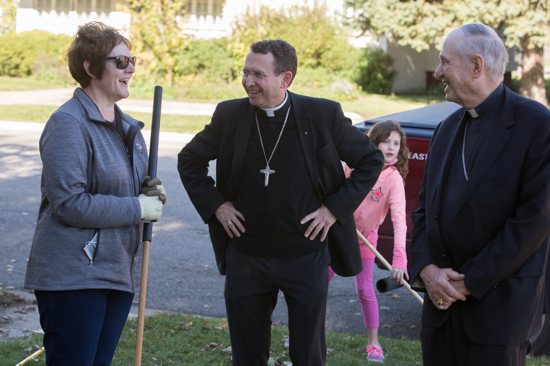 COZZENS 6 Bishop Pates, left, and Bishop Cozzens, center, talk with Jennnifer LeMire, left, a third-grade teacher at Sacred Heart School in East Grand Forks.