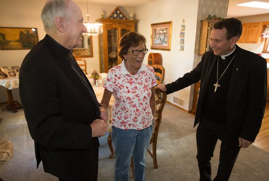 Bishop Richard Pates, apostolic administrator of the Diocese of Crookston, left, and Bishop-designate Andrew Cozzens, right, meet Rosie O’Leary, center, a lifelong parishioner of Sacred Heart in East Grand Forks and mother of 10, all of whom attended Catholic schools. Their visit was part of Bishop Cozzens’ introduction to the Diocese of Crookston Oct. 18, the day it was announced that Pope Francis had named him its next bishop.