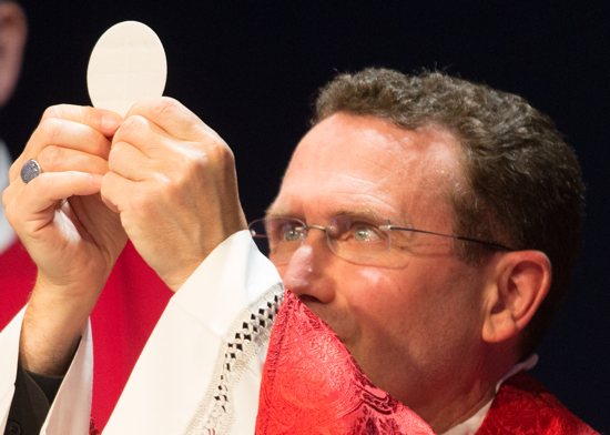 Bishop Andrew Cozzens elevates the Eucharist while celebrating the Mass at the dedication of the new St. Paul’s Outreach building in Mendota Heights