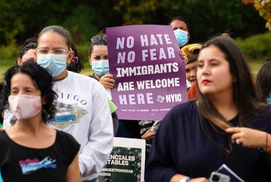 A woman holds a sign during a march and rally in support of immigration reform Oct. 16, 2021, in Riverhead, N.Y. Participants urged Senate Majority Leader Chuck Schumer, D-N.Y., and Congress to pass legislation creating a pathway to citizenship for immigrants living in the U.S. without legal permission.