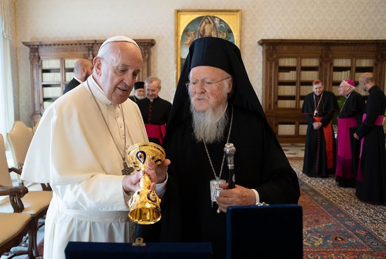 Pope Francis and Ecumenical Patriarch Bartholomew of Constantinople exchanges gifts at the end of a private meeting at the Vatican in this Sept. 17, 2019, file photo. The pope sent good wishes to Patriarch Bartholomew on the 30th anniversary of his election and expressed his gratitude to God for the "profound personal bond" they share.