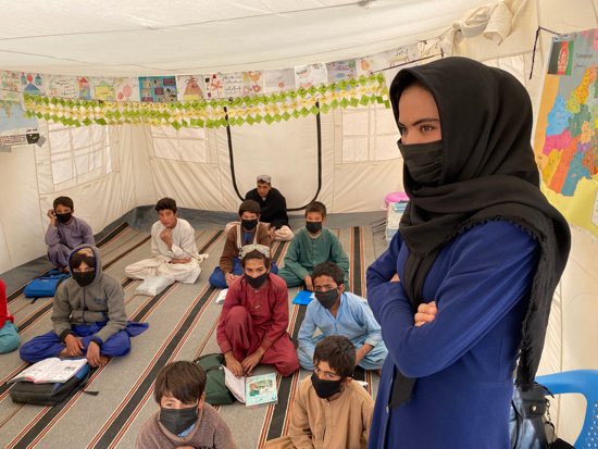 Young people take part in a class sponsored by Catholic Relief Services for displaced children in camps on the outskirts of Herat, Afghanistan, Nov. 2, 2021. CRS is the U.S. bishops' overseas humanitarian rlief and development agency.