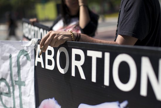 A pro-life demonstrator in Los Angeles holds a rosary while rallying against abortion outside City Hall Sept. 29, 2015. 