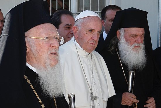 Ecumenical Patriarch Bartholomew of Constantinople, Pope Francis and Orthodox Archbishop Ieronymos II of Athens and all of Greece walk to meet refugees at the Moria refugee camp on the island of Lesbos, Greece, in this April 16, 2016, file photo. Pope Francis plans to meet with Archbishop Ieronymos and other Orthodox leaders during his Dec. 2-6 trip to Cyprus and Greece.
