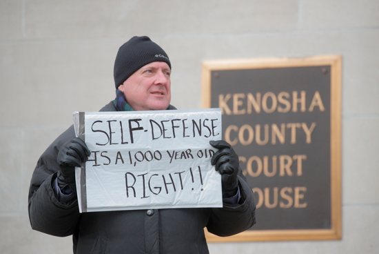 A protester in Kenosha, Wis., stands outside the Kenosha County Courthouse during the trial of Kyle Rittenhouse Nov. 18, 2021. On Nov. 19, the jury acquitted him of the shooting deaths of two people and the wounding another with an AR-15-style rifle Aug. 25, 2020, during civil unrest in Kenosha over the shooting two days earlier of a Black man, Jacob Blake, by a white police officer. Lawyers for Rittenhouse argued their client acted in self-defense.