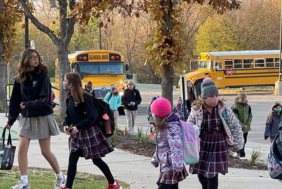 Eighth-grader Kate Cubalchini and sixth-grader Anna Michels enter St. Hubert in Chanhassen Nov. 4. The school has seen enrollment increase from 513 in the 2019-2020 school year to 536 last school year, and 592 this fall.