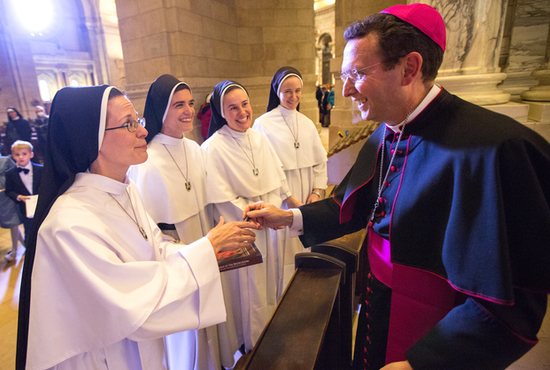 From left, Dominican Sisters of Mary, Mother of the Eucharist Teresa Christi Balek, Mary Consolata Klucik, Maria Karol Hamacher and Philomena Coon greet Bishop Andrew Cozzens after his Mass of Thanksgiving Nov. 28 at the Cathedral of St. Paul in St. Paul.