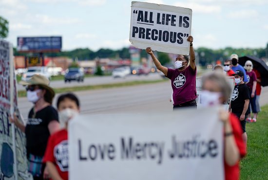 People protesting the death penalty gather near the Federal Correctional Complex in Terre Haute, Ind., July 13, 2020.
