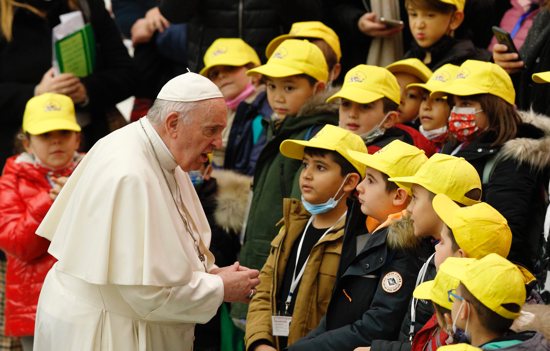 Pope Francis greets children during his general audience in the Paul VI hall at the Vatican Dec. 15, 2021. 