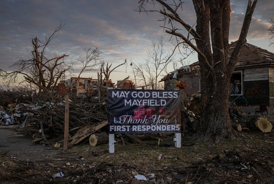 A sign rests in the front yard of a destroyed residence in Mayfield, Ky., Dec. 14, 2021, devastated by a tornado.