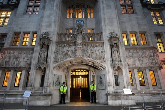 Police officers are pictured in a file photo on duty outside the U.K. Supreme Court in London's Parliament Square. The court ruled Dec. 15, 2021, that police in Northern Ireland were wrong not to investigate allegations that 14 Catholic men were tortured while in custody in the early 1970s. The Police Service of Northern Ireland refused to investigate in 2014, prompting the court case.