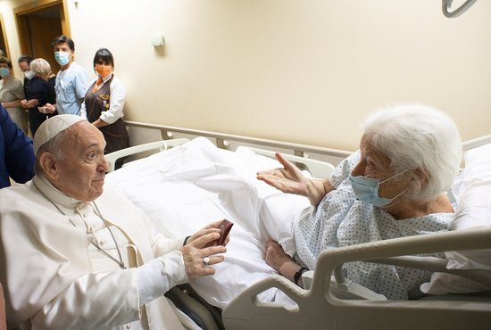 Pope Francis gives a rosary to a patient at Gemelli hospital in Rome July 11, 2021, as he recovers following scheduled colon surgery. The pope was in the hospital for 10 days.
