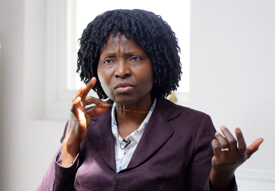 Mary Onuoha, a Catholic nurse from London, is pictured in an undated photo holding up her cross necklace. She successfully claimed at an employment tribunal that she suffered harassment and discrimination from her bosses because she refused to remove the small gold cross from around her neck while she was at work.