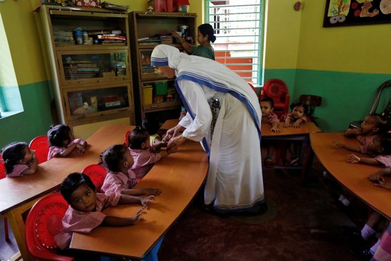 A member of the Missionaries of Charity interacts with the children of a kindergarten inside the Nirmala Shishu Bhavan, a home for orphaned, destitute and abandoned children in Kolkata, India, Aug. 30, 2016. The Indian government has restored the Foreign Contribution Regulation Act registration of the Missionaries of Charity, clearing the decks for the globally renowned charity to receive and utilize foreign funds.