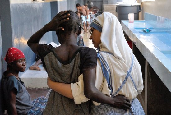 Spanish Missionary of Charity Sister Paul supports a patient at the House for the Dying in Port-au-Prince, Haiti, in this Oct. 16, 2009, file photo. The Vatican released Pope Francis' message for World Mission Sunday, which will be celebrated Oct. 23 with the theme, "You shall be my witnesses." 