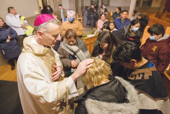 Bishop-elect Joseph Williams gives a blessing after Mass at St. Stephen in Minneapolis Dec. 10, the day he was announced as the next auxiliary bishop for the Archdiocese of St. Paul and Minneapolis.