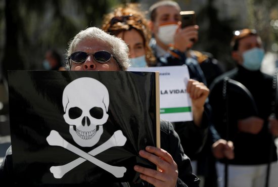 A person holds a sign in Madrid March 18, 2021, protesting a law to legalize euthanasia in Spain. A new study shows violent suicides increase in countries where assisted suicide and euthanasia are legalized.