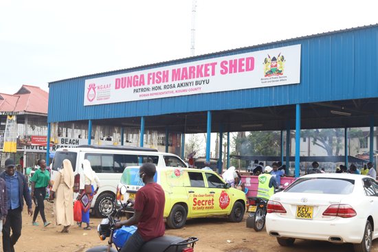 Religious sisters are seen walking through the busy Dunga Beach market in Kisumu, Kenya. Sisters are working to end the dangerous sexual practices that have become widespread in the fishing community.