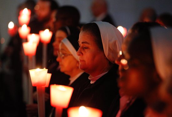 Religious hold candles as Pope Francis celebrates Mass marking the feast of the Presentation of the Lord in St. Peter's Basilica at the Vatican in this Feb. 2, 2017, file photo. In a video message released by the Pope's Worldwide Prayer Network Feb. 1, 2022, Pope Francis offered his prayer intention for the month of February, which he dedicated to religious and consecrated women.