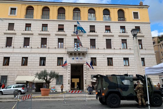 An Italian military vehicle and soldier performing regular guard duties are seen outside the building housing the Russian Embassy to the Holy See and other embassies on Via della Conciliazione, the main road leading to the Vatican, Feb. 25, 2022. Pope Francis visited the Russian Embassy to the Holy See in the morning the same day to express his concern about the war in Ukraine.