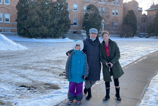 Psyrenity and her 9- and 11-year-old children stand in front of their temporary residence at Project Home, the former provincial house for the Sisters of St. Joseph of Carondelet in St. Paul.