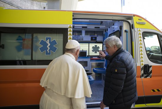 Pope Francis talks with Cardinal Konrad Krajewski, the papal almoner, during the blessing of an ambulance to donate to the Ukrainian city of Lviv, at the Vatican March 26, 2022. Cardinal Krajewski left the Vatican March 26 to drive the ambulance to Lviv.