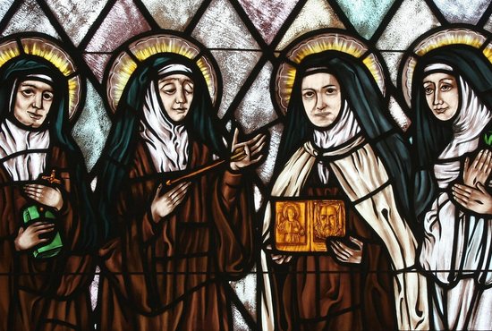 Sts. Edith Stein, Teresa of Ávila, Therese of Lisieux and Catherine of Siena are represented in stained glass at St. Thérèse of Lisieux Church in Montauk, N.Y. The Catholic Church needs women saints, Pope Francis said in a message to a conference in Rome on "Women Doctors of the Church and Co-Patronesses of Europe." 