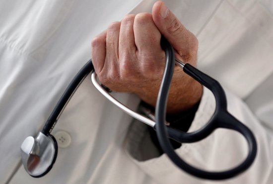 A doctor holds a stethoscope in this illustration photo.