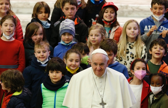 Pope Francis poses for a picture with children during his general audience in the Paul VI hall at the Vatican April 13, 2022.