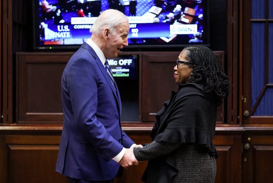 President Joe Biden holds hands with Supreme Court nominee Judge Ketanji Brown Jackson as they watch the full U.S. Senate vote on Jackson's nomination to the U.S. Supreme Court from the Roosevelt Room at the White House in Washington April 7, 2022. Jackson was confirmed 53-47.