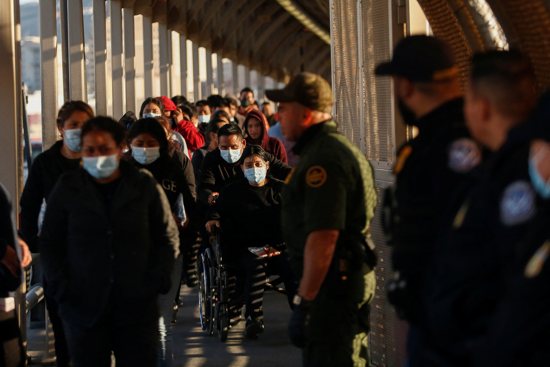 Migrants expelled from the U.S. and sent back to Mexico under Title 42 walk toward Mexico at the Paso del Norte International border bridge in Ciudad Juarez, Mexico, April 1, 2022. 