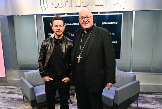 Catholic actor Mark Wahlberg poses with New York Cardinal Timothy M. Dolan at SiriusXM Studios in New York April 7, 2022. Wahlberg sat down with the cardinal to talk about his new movie "Father Stu" for "Conversation with Cardinal Dolan," which is broadcast on SiriusXM's The Catholic Channel.