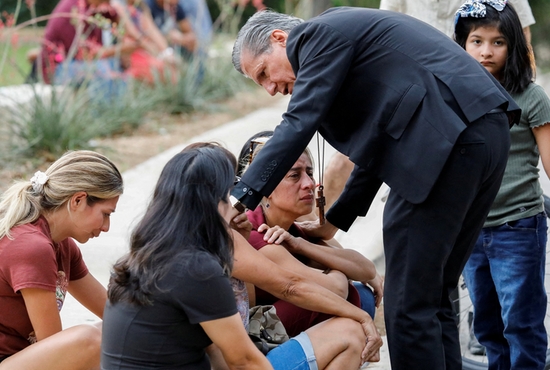  Archbishop Gustavo García-Siller of San Antonio comforts people in Uvalde, Texas, outside the SSGT Willie de Leon Civic Center, where students had been transported from Robb Elementary School after a shooting May 24, 2022. 