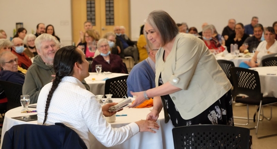 Marilyn Jackson, director of ministry services for the Diocese of Sasktatoon, Saskatchewan, presents a gift to Chief Cadmus Delorme of the Cowessess First Nation April 28, 2022.