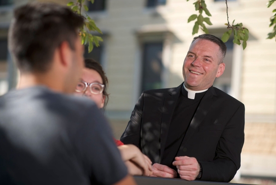 Father Burns with students