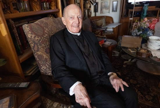 Father George Welzbacher uses his room at the Leo C. Byrne Residence in St. Paul to read and write poetry. It’s where he put the finishing touches on a poem he had been working on for 44 years, “Galactic Shepherd.”